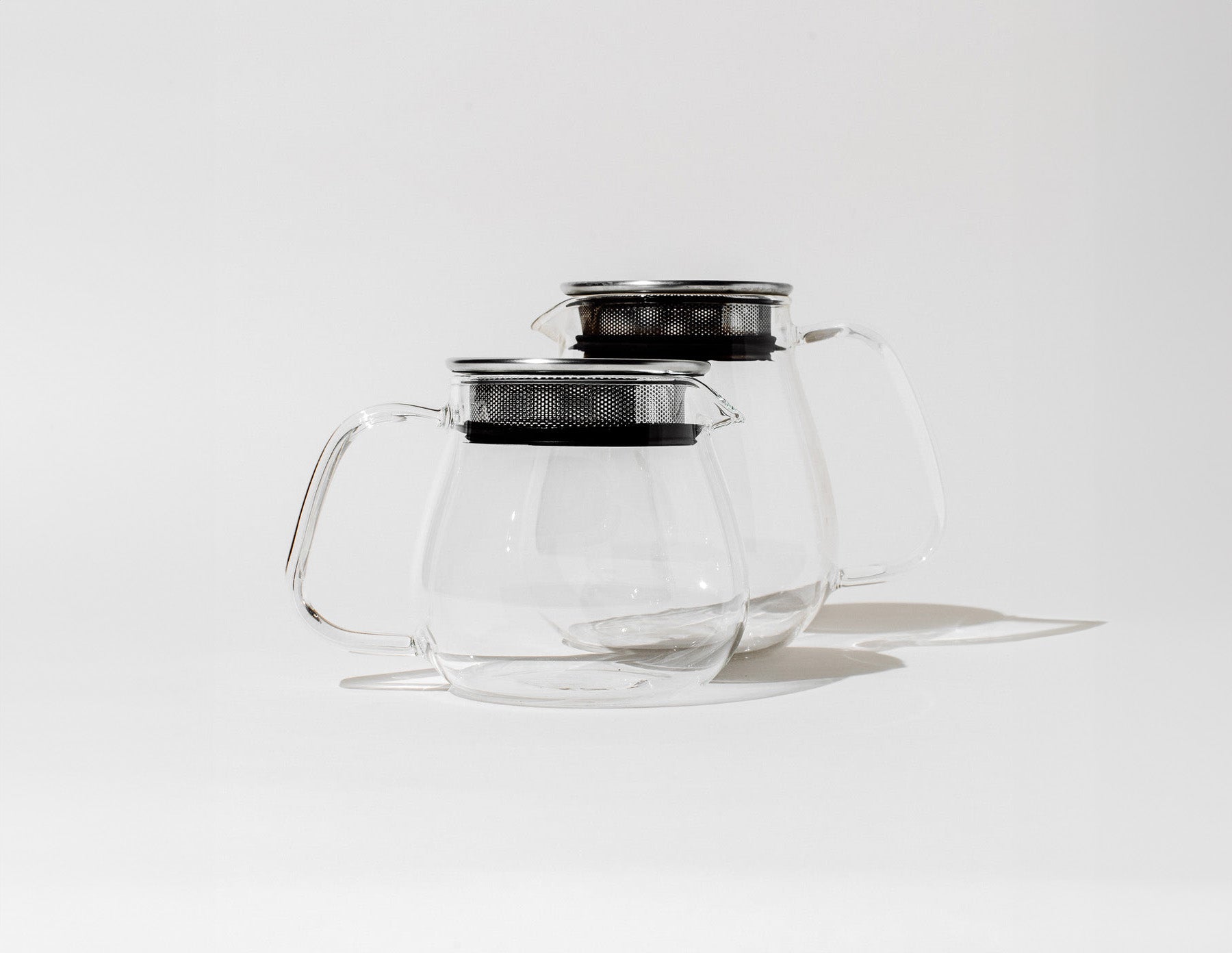 Atomic Fungi's premium teapots with built-in infusers against a clean, grey-white photo background.